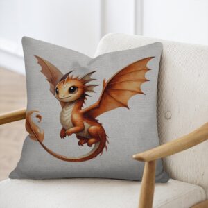 Square throw pillow featuring a cute illustration of a friendly orange baby dragon with wide dark eyes, spread wings, and a flame-tipped tail against a light beige woven fabric background.